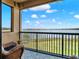 A stylish tiled balcony with scenic lake and lawn views creates a serene outdoor retreat at 16300 County Road 455 # 201, Montverde, FL 34756