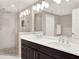 Bathroom features double sink vanity, glass enclosed shower, and tiled floors at 16300 County Road 455 # 201, Montverde, FL 34756