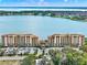 A grand lakeside resort building with parking set against a beautiful lake backdrop at 16300 County Road 455 # 201, Montverde, FL 34756