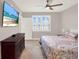 Bright main bedroom features wood floors, ceiling fan, and TV on the wall at 16300 County Road 455 # 201, Montverde, FL 34756