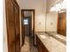 Bathroom vanity featuring granite countertop, undermount sink, and wood cabinets at 1811 Springwood Ln, Deltona, FL 32725