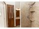 Updated bathroom with a tiled shower featuring shelving and wood framed doorway at 1811 Springwood Ln, Deltona, FL 32725