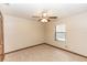 Comfortable bedroom features neutral carpet, ceiling fan, closet and window for natural light at 1811 Springwood Ln, Deltona, FL 32725