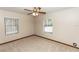 Cozy bedroom with neutral carpet, ceiling fan, and two windows providing natural light at 1811 Springwood Ln, Deltona, FL 32725