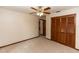 Large bedroom featuring neutral carpet, closet, and connecting bathroom and hallway at 1811 Springwood Ln, Deltona, FL 32725