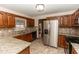 Updated kitchen featuring stainless appliances, mosaic backsplash, and granite countertops at 1811 Springwood Ln, Deltona, FL 32725