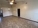 Spacious living room featuring tiled flooring, a ceiling fan, and access to other rooms at 1811 Springwood Ln, Deltona, FL 32725