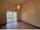 Open-plan living room with chandelier, sliding glass doors and tiled flooring at 1811 Springwood Ln, Deltona, FL 32725