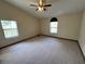 Large main bedroom with plush carpet, neutral walls, and plenty of natural light from multiple windows at 1811 Springwood Ln, Deltona, FL 32725