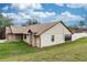 The home's rear exterior showcasing a large backyard and sunroom at 1811 Springwood Ln, Deltona, FL 32725