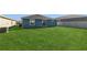 View of expansive green backyard featuring new construction at 1950 Birnham Wood Bnd, Kissimmee, FL 34746