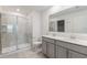 Modern bathroom featuring dual sinks, a shower, and tile floors at 1950 Birnham Wood Bnd, Kissimmee, FL 34746