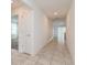 Hallway featuring neutral tile flooring, recessed lighting, and white doors with a view into a living room at 1950 Birnham Wood Bnd, Kissimmee, FL 34746