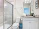 Bathroom featuring a tiled shower, white cabinets, and a granite countertop at 201 Jetty Way, Davenport, FL 33897