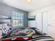 Well-lit bedroom with a queen bed, ocean view television, and closet at 201 Jetty Way, Davenport, FL 33897