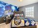 Themed bedroom featuring a queen bed and castle mural at 201 Jetty Way, Davenport, FL 33897