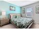 Bright bedroom with a queen bed, stylish bedding, and ample natural light at 201 Jetty Way, Davenport, FL 33897