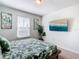 Bedroom featuring a queen bed, tropical bedding, and a mounted television at 201 Jetty Way, Davenport, FL 33897