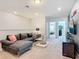 Upstairs living room showing comfortable gray sofa, view of the hallway to the bedrooms and entertainment center at 201 Jetty Way, Davenport, FL 33897