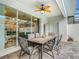 Outdoor patio with ceiling fan and dining table with seating for six at 201 Jetty Way, Davenport, FL 33897