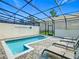 A private screened-in pool and sun loungers provide a serene outdoor retreat at 201 Jetty Way, Davenport, FL 33897