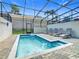 Enclosed pool area with lounge chairs and clear blue pool water at 201 Jetty Way, Davenport, FL 33897