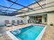 Enclosed pool area with clear blue water, inflatable float, and outdoor lounge seating at 201 Jetty Way, Davenport, FL 33897