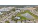 Extensive aerial view of neighborhood with clubhouse, pool, multiple ponds and townhome buildings at 209 Arbor Lakes Dr, Davenport, FL 33896