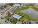 Aerial view of a community featuring a pool, clubhouse, and pond with water fountain at 209 Arbor Lakes Dr, Davenport, FL 33896