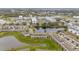 Aerial view of community featuring townhomes, water features, and mature landscaping at 209 Arbor Lakes Dr, Davenport, FL 33896