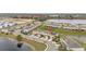 Aerial view of a residential neighborhood showcasing townhomes and water features at 209 Arbor Lakes Dr, Davenport, FL 33896