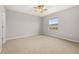 Cozy bedroom featuring neutral paint, plush carpet, ceiling fan, and a window offering natural light at 209 Arbor Lakes Dr, Davenport, FL 33896