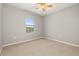 The bedroom shows neutral walls, carpet flooring and a window at 209 Arbor Lakes Dr, Davenport, FL 33896