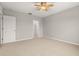 Comfortable carpeted bedroom with ceiling fan, neutral paint, closet and ample natural light at 209 Arbor Lakes Dr, Davenport, FL 33896