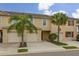 Inviting townhome featuring a 1-car garage, desert landscaping and a charming exterior design at 209 Arbor Lakes Dr, Davenport, FL 33896