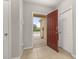 Inviting foyer with a red front door, neutral walls and tile flooring at 209 Arbor Lakes Dr, Davenport, FL 33896