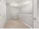 Upstairs hallway features neutral paint and carpet, and bright natural light at 209 Arbor Lakes Dr, Davenport, FL 33896