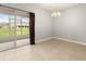 Bright living room featuring tile flooring, and sliding glass doors to a screened-in lanai at 209 Arbor Lakes Dr, Davenport, FL 33896