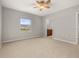 Main bedroom with neutral walls and carpet, ceiling fan, and an en suite bathroom at 209 Arbor Lakes Dr, Davenport, FL 33896