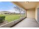 The screened patio overlooks a pond and manicured lawn at 209 Arbor Lakes Dr, Davenport, FL 33896