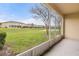 Screened patio overlooks the lawn and pond at 209 Arbor Lakes Dr, Davenport, FL 33896