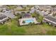 Aerial view of a community pool surrounded by palm trees and lounge chairs at 209 Arbor Lakes Dr, Davenport, FL 33896