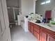 Bathroom featuring double sinks, a soaking tub, and a tiled shower with glass doors at 2119 Kaylas Ct, Orlando, FL 32817