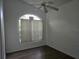 View of the bedroom with wooden floors, and a large window at 2119 Kaylas Ct, Orlando, FL 32817