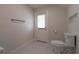 Bright bathroom featuring white toilet, tile flooring, and a door with window at 2721 Ingeborg Ct, Windermere, FL 34786