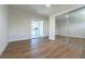 Bright bedroom with wood floors, mirrored closet, and access to outdoor balcony at 2721 Ingeborg Ct, Windermere, FL 34786