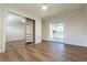 Bedroom featuring wood floors, a closet with sliding mirror doors, and sliding glass doors to the patio at 2721 Ingeborg Ct, Windermere, FL 34786