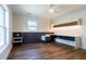 Well-lit bedroom with hardwood floors, a built-in desk and shelving, and neutral tones at 2721 Ingeborg Ct, Windermere, FL 34786