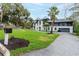 View of the home's exterior with a well-manicured lawn, sprinkler system, and paver driveway at 2721 Ingeborg Ct, Windermere, FL 34786