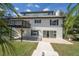 Rear exterior of home with access to backyard pool, lush landscaping, and an upper level balcony at 2721 Ingeborg Ct, Windermere, FL 34786